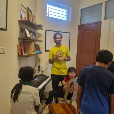 A day in our life at AMP. An instructor engaging with students in a group setting, fostering a fun and interactive learning environment.