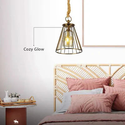 This industrial-style cage pendant with a rope detail adds a cozy glow to the bedroom. It's a perfect example of how I use lighting to create a feeling of luxury and comfort.