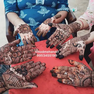 A beautiful group shot of the bride and her family showing off their mehendi. I can cater to the entire bridal party with a variety of designs.