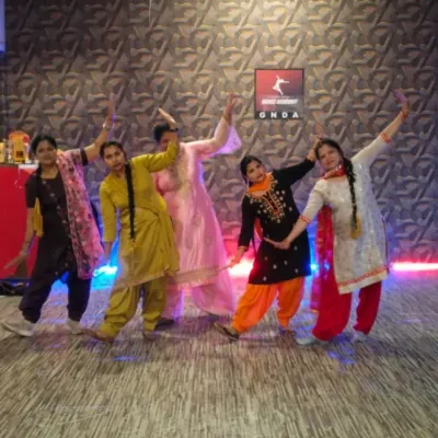 A powerful pose from our ladies' batch after a successful workshop. Dressed in traditional Punjabi attire, they showcase the energy and camaraderie of our classes.