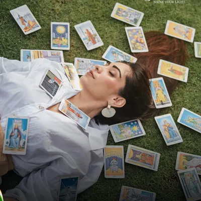 This image captures the essence of my connection with tarot. Lying on the grass, surrounded by cards, I found my own kind of freedom. It's a reminder that the answers we seek are often found when we connect with ourselves and the universe.