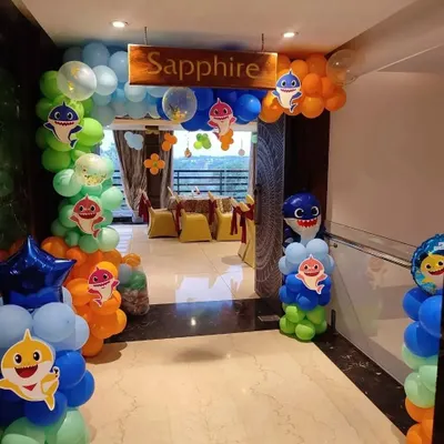 A fun and colorful entrance for a 'Baby Shark' themed birthday party. This setup includes custom balloon columns, character cutouts, and a themed archway to welcome guests and set the tone for the celebration.