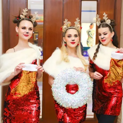 A group of performers in festive reindeer costumes at a Christmas event. Themed parties are a fantastic opportunity for fun and creative photography.