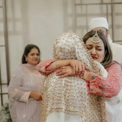 The emotional farewell. A bride shares a tearful hug with her sister, a powerful and candid moment that speaks volumes about their bond. We capture these heartfelt goodbyes with sensitivity.