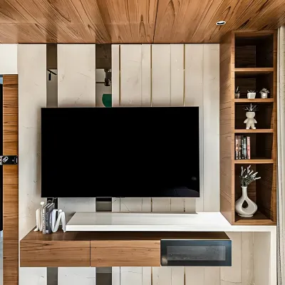 A close-up of a modern TV unit featuring a mix of wood and white finishes. The design includes a sleek soundbar shelf and a vertical display niche, demonstrating our attention to both aesthetics and media integration.
