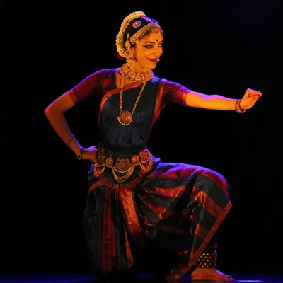 This pose from my production 'Shringara Sharanagati' is a powerful representation of surrender in love and devotion. The costume, lighting, and posture all come together to tell a story, which is the essence of my stage choreography.