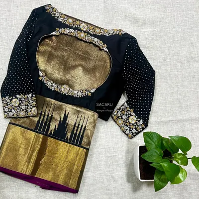 Gold, silver, and black make for a timeless combination. We designed this black silk and georgette blouse with gold and silver zari hand embroidery to pair with a classic Kanjeevaram saree.