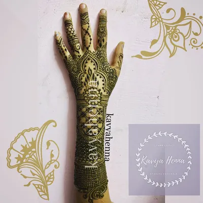 An intricate party henna design extending from the fingers to the wrist. This piece features a central candle motif surrounded by detailed geometric and floral patterns, perfect for a festive occasion.