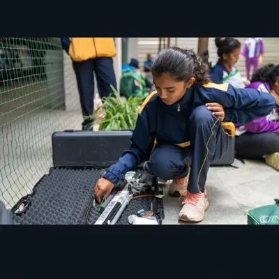 Every detail matters. A young shooter carefully unpacks and prepares her precision air rifle before a competition, a crucial part of the pre-match ritual.