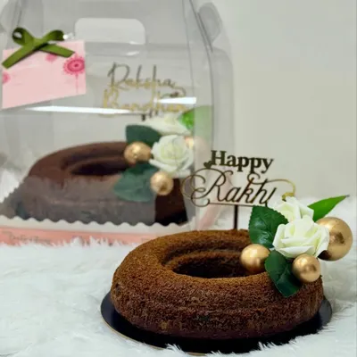 Rakhi is here, and so are my exclusive hampers! This image showcases a rich brownie tower and a wholesome whole-wheat jaggery cake, perfect for celebrating the sweet bond between siblings.