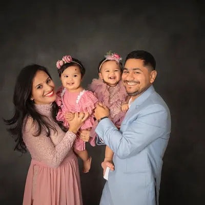 Double the giggles and double the love with these twin queens and their proud parents. This family portrait celebrates the beautiful chaos and joy of having two little ones.