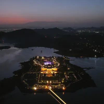 A dusk aerial view of the magnificent Raffles Udaipur, a modern palace hotel situated on its own private island. This shot was taken with my DJI Mavic 3 to capture the warm lighting, intricate design, and serene lake setting, perfect for a luxury hotel promo video.