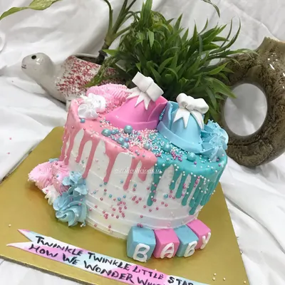 From pastel dreams to tiny booties, my baby shower cakes are as special as your celebration. This gender reveal cake features pink and blue drips, sprinkles, and adorable fondant baby shoes.