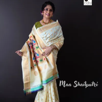 We began the Navdurga series with Maa Shailputri, representing purity and innocence in this beautiful white Paithani saree. This studio portrait uses a simple dark background to let the intricate details of the saree and the subject's graceful pose shine.