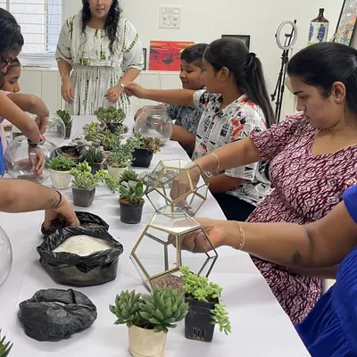 A table full of aspiring gardeners! Our terrarium workshop is a crowd favorite, where participants create their own miniature succulent gardens in beautiful glass bowls.