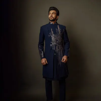 With my tailored precision, Pratik Gandhi proves that style is the ultimate power move. This asymmetrical navy bandhgala with architectural embroidery makes a strong, confident statement.