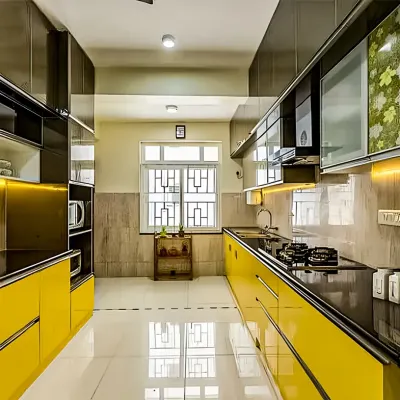 This parallel kitchen makes a bold statement with vibrant yellow high-gloss cabinets. The layout maximizes storage and counter space on both sides, while the reflective surfaces make the galley feel wider.
