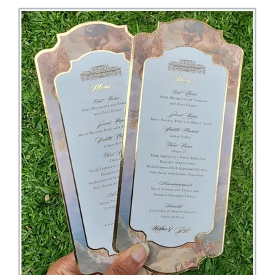 These stunning menu cards were designed for a beautiful wedding in Rome. The design features a classic cherub illustration and elegant typography, printed on custom-shaped cards with a gold foil border.