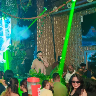 Here I am on the mic at Happy Brew, with the green lasers setting the mood. The vibe here is always electric, especially on a Thursday ladies' night.