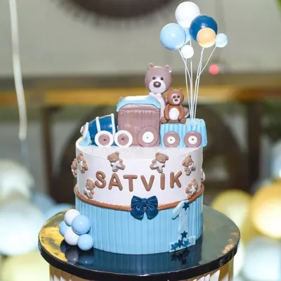 A close-up of an adorable teddy bear and train themed birthday cake for a little boy named Satvik. We capture the artistry of your custom birthday cakes.