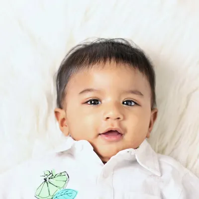 A beautiful close-up portrait of one of the twin boys from a six-month milestone session. Capturing individual shots is just as important as capturing them together.