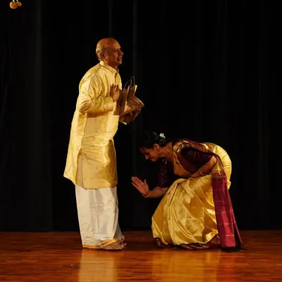 A moment of deep respect. A student seeks blessings before a performance, a gesture that embodies the spirit of the Guru-Shishya tradition.