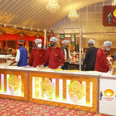 A beautifully lit food counter with decorative masks, ready for an evening reception. I believe the service of food is the service of energy, and the presentation should reflect that.