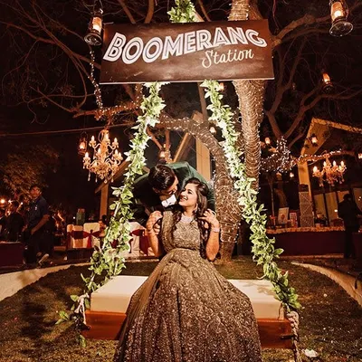 Creating the perfect photo moment is part of the job. This "Boomerang Station" swing, wrapped in fairy lights and set against a backdrop of chandeliers, was a huge hit at this wedding reception.