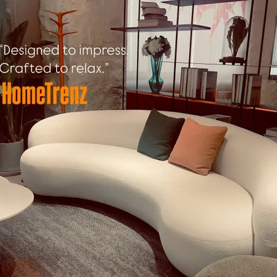 Designed to impress, crafted to relax. This custom curved sofa in a textured white fabric acts as the centerpiece of the living room, offering both style and supreme comfort.