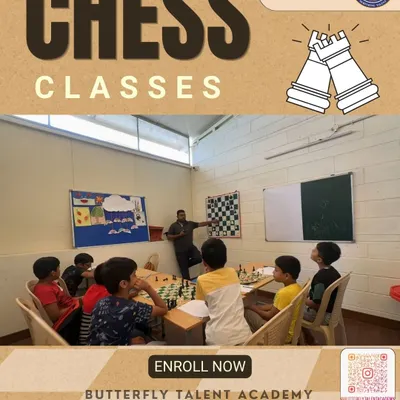 A view of our weekend chess coaching in session. Our instructor uses a large, wall-mounted chessboard to explain tactics to a group of engaged young students, who follow along on their own boards.