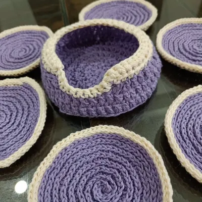 This is my coaster set in a lovely lavender and cream color combination. The set includes six round coasters and a small holder, all crocheted from soft cotton yarn.