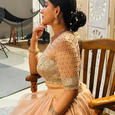 Akanksha is glowing in this custom organza layered skirt and gotta blouse. The blouse features a gotta patti patch embossed into the fabric, which is further uplifted with zari, zardosi, beads, and sequins.