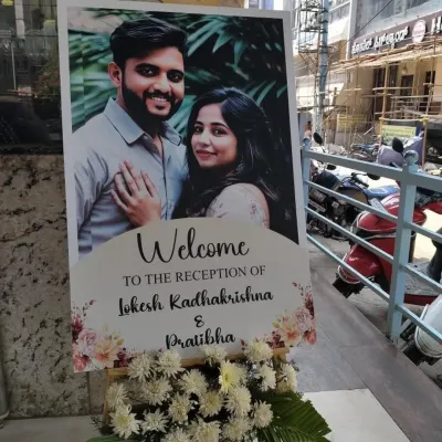 For this wedding reception in JP Nagar, I designed a clean and elegant welcome sign featuring a lovely photo of the couple. Placed at the entrance with a simple floral arrangement, it warmly greeted all the arriving guests.