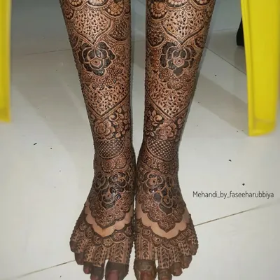 A full bridal leg design, featuring intricate patterns that extend from the toes up to the shins.