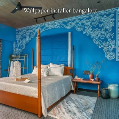 A solid blue Roman blind installed to provide full light blocking in a master bedroom. The clean folds of the fabric give a neat appearance when raised or lowered.