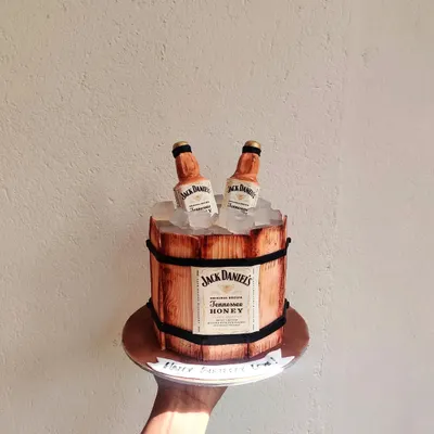 Is it cake? Yes, it is! This Jack Daniels barrel cake is one of my favorite creations, made entirely without fondant. The wood grain texture is hand-painted, and the "ice" is made from edible sugar crystals.
