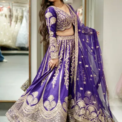 In the language of colors, this lehenga says majestic. A stunning royal purple lehenga with intricate silver and gold embroidery that creates a look of pure royalty.