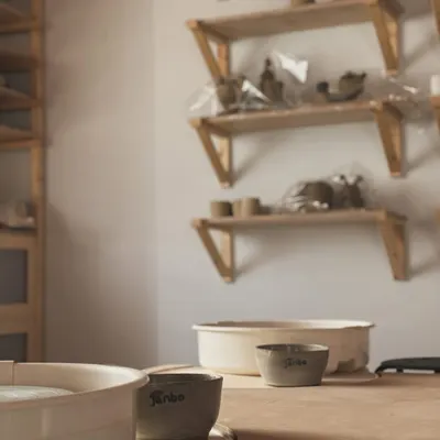 A quiet corner of my studio. The pottery wheel, some water bowls, and shelves of works-in-progress. This is where I come to find my peace and create.