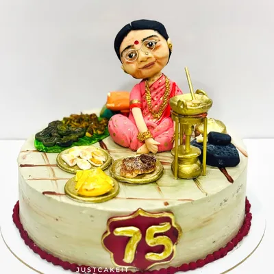 A very special cake for a 75th birthday, featuring a hand-molded caricature of the beloved 'Aai' (mother) surrounded by her favorite traditional foods, all edible.