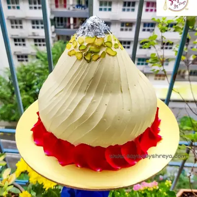 This is my showstopper for the festival: a cake sculpted and frosted to look exactly like a traditional modak. Garnished with pistachios and edible silver leaf (vark), it makes for a truly memorable centerpiece for your Ganesh Chaturthi celebrations.