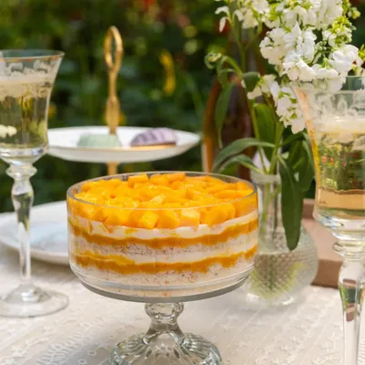 Summer in a bowl. My Mango Cream Cheese Trifle is layered with soft cake, light cream, and heaps of fresh, sweet mango.