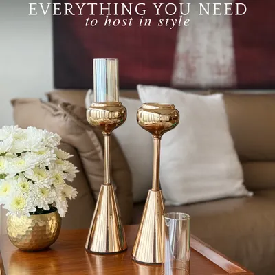 Our Vesper candle holders, with their sleek golden form, are paired with a matching hammered gold vase. This set is designed to bring a cohesive and luxurious touch to any side table or console.