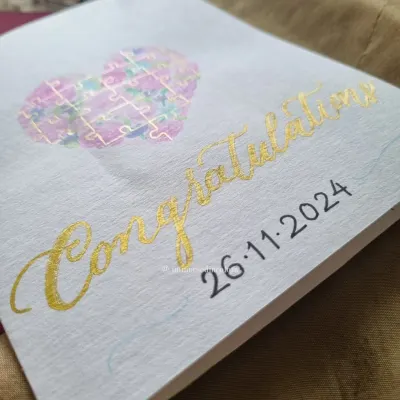 This congratulations card was made for a couple who loves jigsaw puzzles. I painted a watercolor heart filled with puzzle pieces and finished it with gold calligraphy.