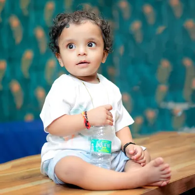 A simple, candid portrait of a baby boy during his birthday shoot. His wide-eyed, curious expression is what makes this shot so special.