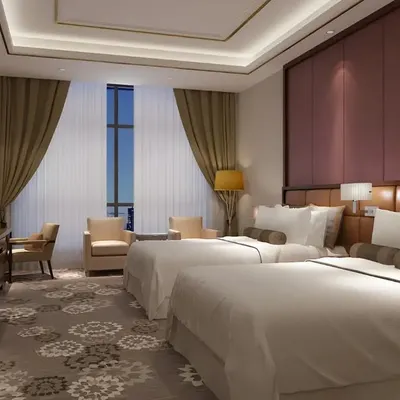 Our design work extends to creating premium hospitality experiences. This twin guest room combines comfort with high-end style, featuring a full-height padded headboard wall, sophisticated lighting, and a rich color palette to ensure a restful and luxurious stay for any guest.