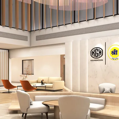 A view of the double-height waiting area in Jaipur, showcasing the interplay of light, volume, and texture. The design uses suspended wooden fins and built-in seating to create distinct zones within the larger open space, balancing grandeur with intimacy.
