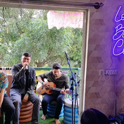 A beautiful moment from a Loysum Balcony Concert. You can see the intimate setup, with artists performing on the balcony for a small audience. It's all about togetherness and the joy of music.