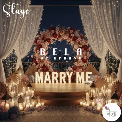 The complete vision for a grand proposal. This rooftop setup includes a custom floral arch, large illuminated 'MARRY ME' letters, and a floor filled with candles, all framed by soft white drapery.