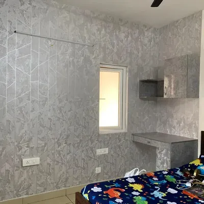 This project showcases a fully coordinated room design. I applied the same geometric and textured silver wrap to the main wall, the study desk surface, and the front of the wall-mounted cabinets, creating a seamless and sophisticated look.