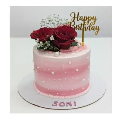 A tall and elegant cake for Soni's birthday. This choco-vanilla cake features a pink ombre design with pearl sprinkles and is topped with fresh red roses.